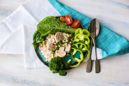 Healthy food concept with mushrooms in sour sauce and fresh vegetables on wooden tableの写真素材