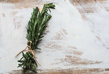 Fresh rosemary spice on rustic wooden background with copyspaceの写真素材