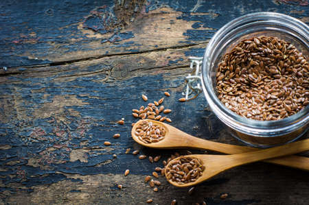 Organic food concept with flax seeds on dark wooden backgroundの写真素材