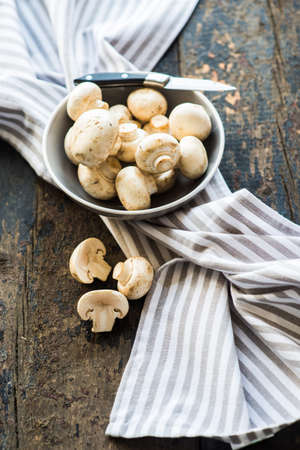 Organic food concept with fresh mushrooms on dark wooden tableの写真素材