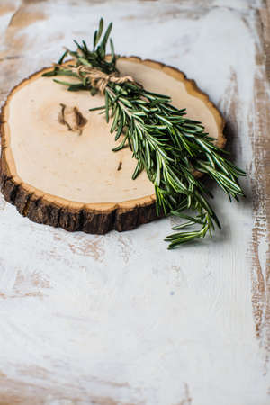 Fresh rosemary spice on rustic wooden background with copyspaceの写真素材