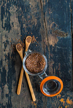 Organic food concept with flax seeds on dark wooden backgroundの写真素材