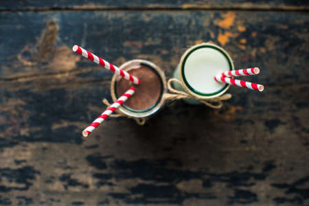 Glass of milk on dark wooden rustic table with copyspaceの写真素材