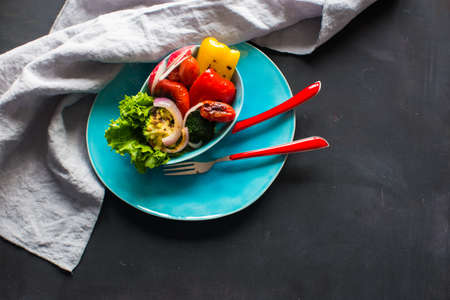 Healthy food concept with grilled fresh organic vegetables on dark wooden tableの写真素材