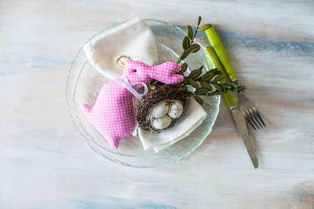 Festive table setting for Easter dinner on wooden rustic tableの写真素材