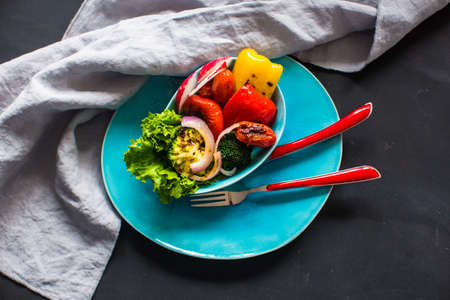 Healthy food concept with grilled fresh organic vegetables on dark wooden tableの写真素材