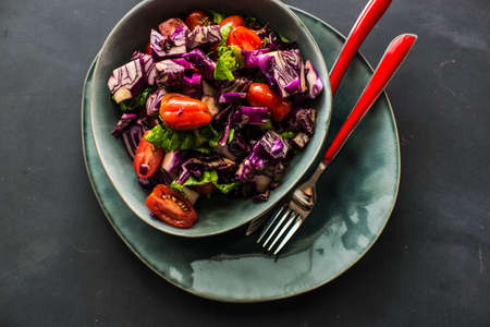 Healthy food concept with  fresh organic vegetables as a ingredients for salads on dark wooden tableの写真素材