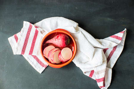 Fresh sliced organic radish vegetable on a cutting board