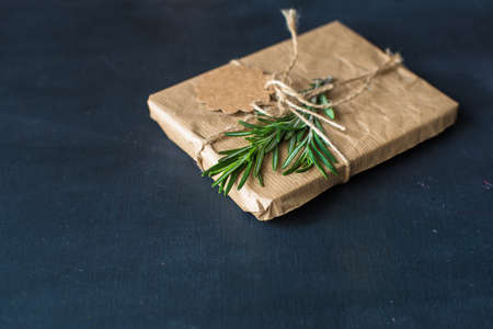 Easter gift boxes with rosemary on dark wooden backgroundの写真素材