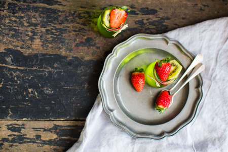 Jelly kiwi and strawberry desset on rustic table with copyspaceの写真素材