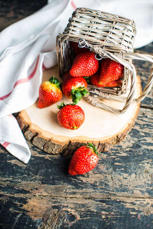Fresh ripe organic strawberry fruits on dark wooden background