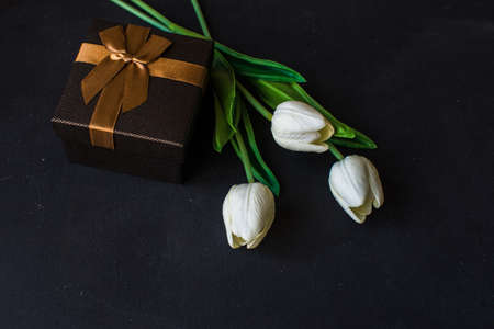 Tulips and git box on dark backgroundの写真素材