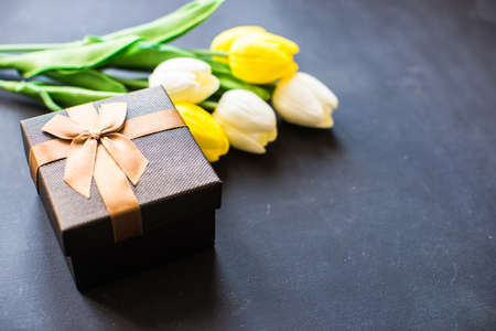 Tulips and git box on dark backgroundの写真素材