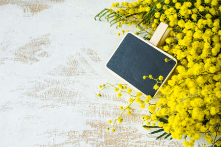 Spring frame with fresh mimosa flowers on wooden backgroundの写真素材