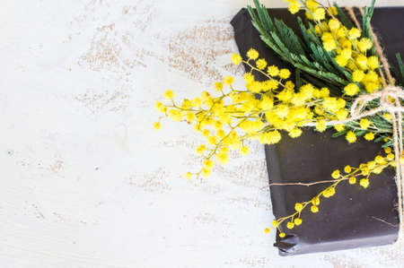 Spring frame with fresh mimosa flowers on wooden backgroundの写真素材