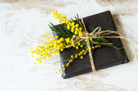 Spring frame with fresh mimosa flowers on wooden backgroundの写真素材