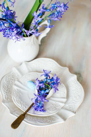 Rustic table setting with blue hyacinth  on wooden table