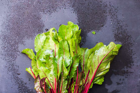 Fresh organic beet with leaves on dark wooden backgroundの写真素材