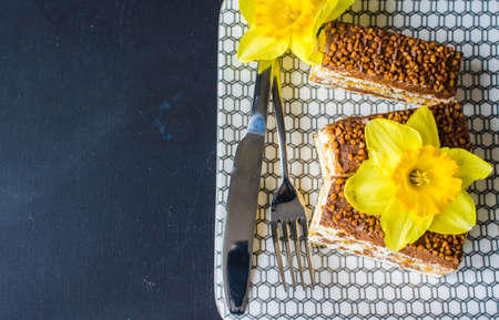 Vanilla and chocolate biscuit cake on rustic wooden tableの写真素材