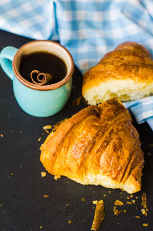 Fresh homemade french croissant on dark wooden table