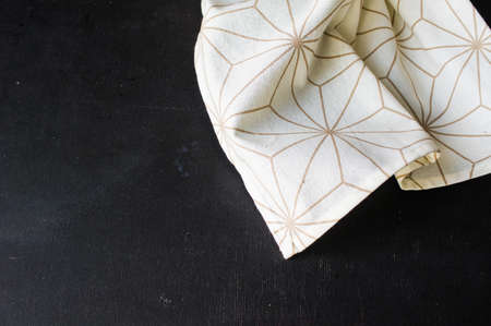 Kitchen towel or napkin over the rustic wooden table. View from above with copy spaceの写真素材