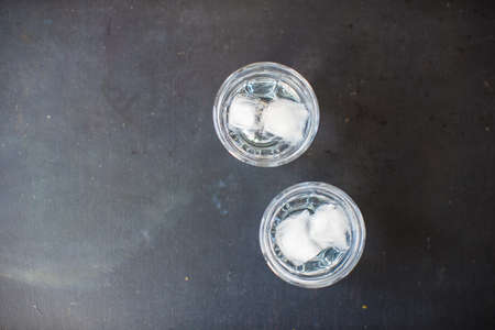 Summer drink glass of water with ice on dark backgroundの写真素材