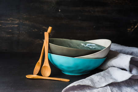 Empty rustic bowl and vintage wooden spoons on old wooden tableの写真素材