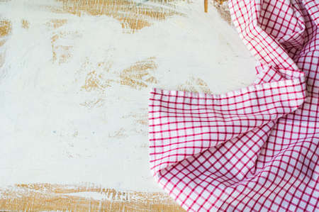 Kitchen towel or napkin over the rustic wooden table. View from above with copy space
