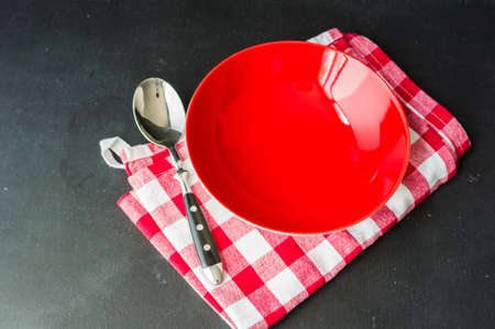 Empty rustic bowl and vintage wooden spoons on old wooden table