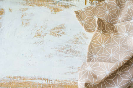 Kitchen towel or napkin over the rustic wooden table. View from above with copy spaceの写真素材
