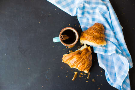 Fresh homemade french croissant on dark wooden tableの写真素材