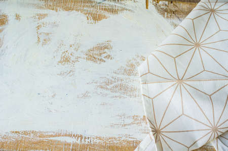Kitchen towel or napkin over the rustic wooden table. View from above with copy space