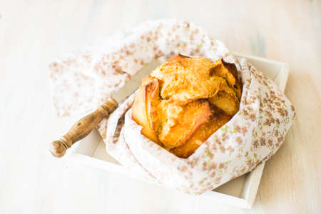 Fresh homemade bread with rustic towel on dark wooden table with copyspace