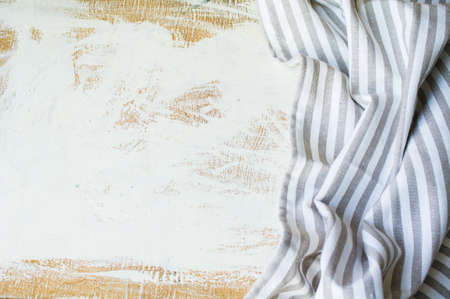 Kitchen towel or napkin over the rustic wooden table. View from above with copy space