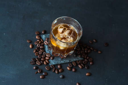 Alcohol coffee liqueur with coffee beans on dark wooden tableの写真素材