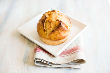 Fresh homemade bread with rustic towel on dark wooden table with copyspaceの写真素材