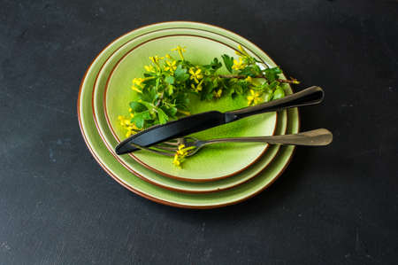 Spring table setting with blooming tree branch with  yellow flowers