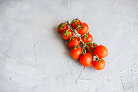 Organic tomatoes on grey concrete backgroundの写真素材
