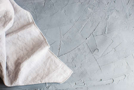 Kitchen towel or napkin over the rustic concrete table. View from above with copy space