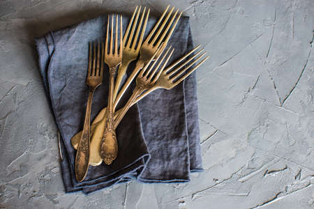 Vintage silverware on rustic concrete covered grey tableの写真素材