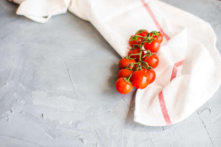 Organic tomatoes on grey concrete backgroundの写真素材