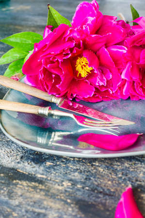 Summer table setting with purple peonies with copyspaceの写真素材
