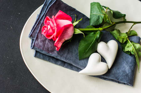 Table setting with red rose for Valentines day dinner