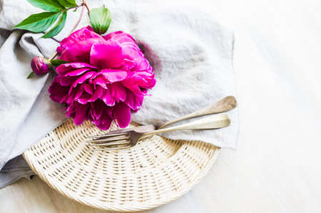 Summer table setting with purple peonies with copyspaceの写真素材