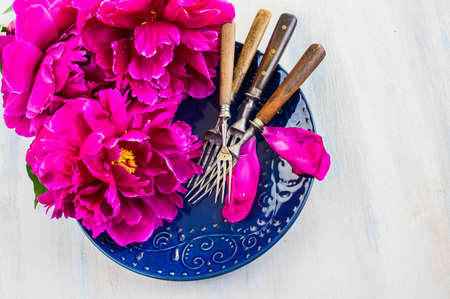 Summer table setting with purple peonies with copyspaceの写真素材