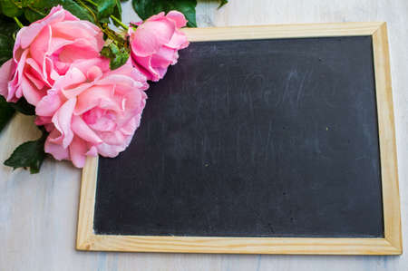 Summer frame with roses on dark wooden backgroundの写真素材