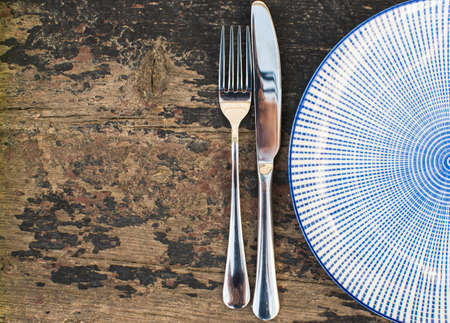 Rustic table setting - vintage silverware and cotton napkin  on dark background with copyspaceの写真素材
