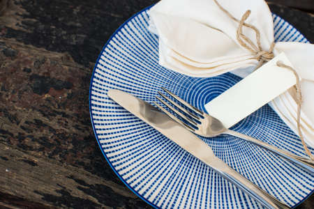 Rustic table setting - vintage silverware and cotton napkin  on dark background with copyspaceの写真素材