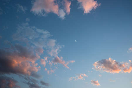 Blue sky in sunset time with clouds and moon
