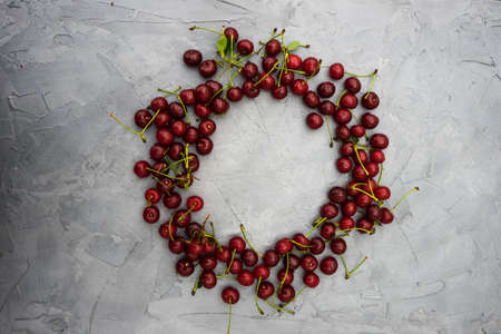 Fresh cherry berries on rustic concrete backgroundの写真素材